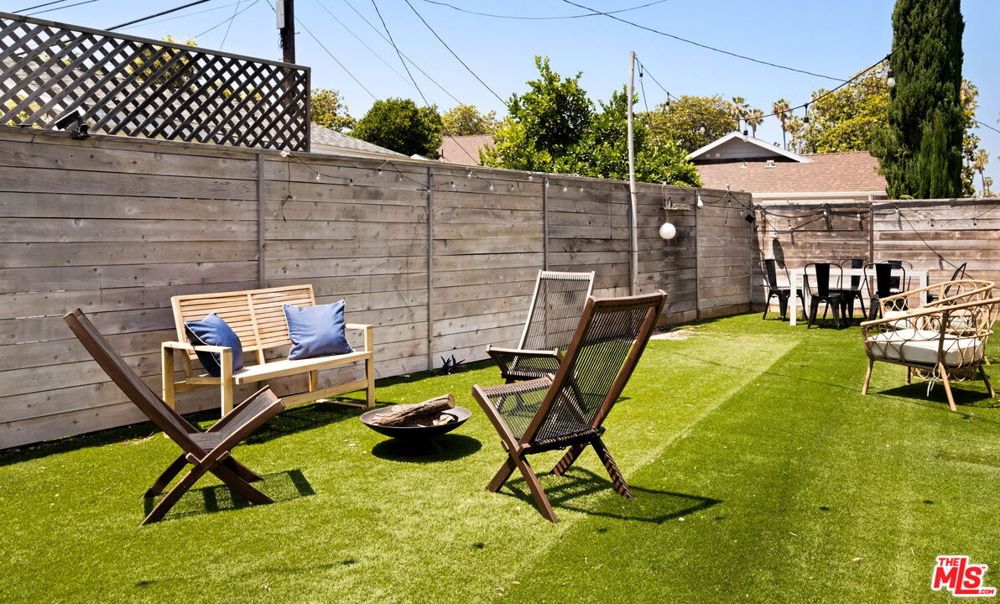 Private fenced backyard with seating