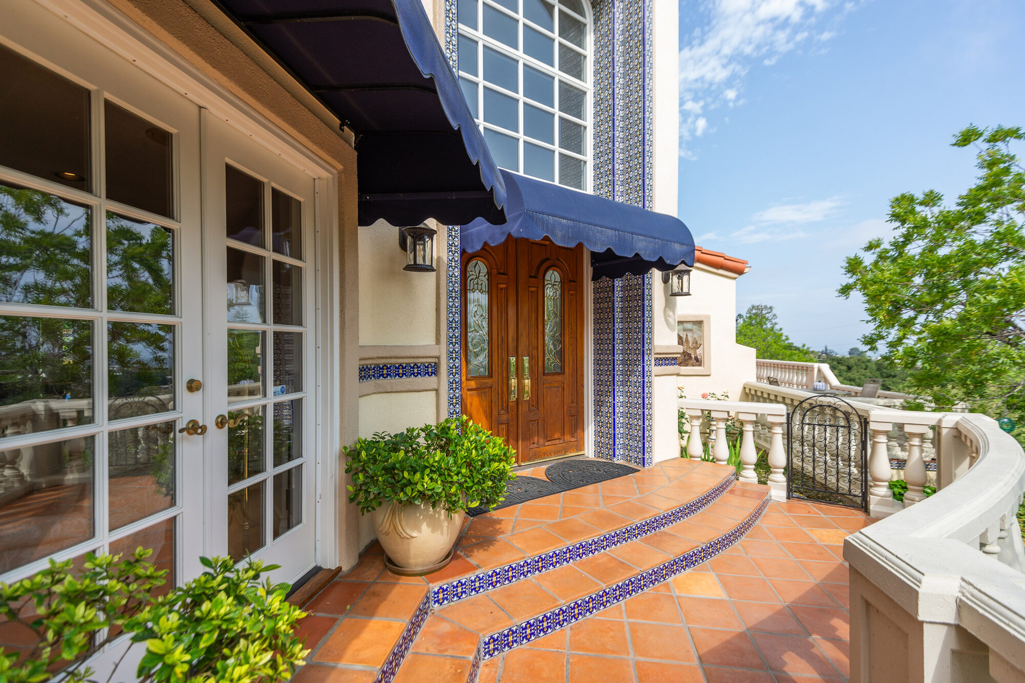 Front entry with hand-painted tile and terracotta steps